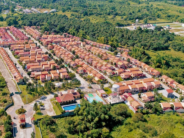 Inside Camella Bataan community with gate, clubhouse, swimming pool, basketball court, and greeneries