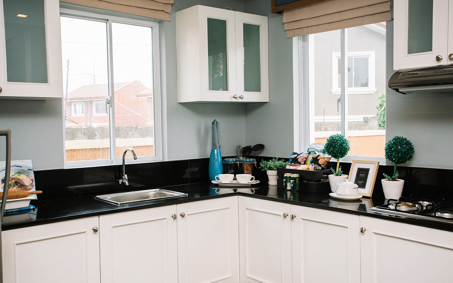 Ella home kitchen area with cabinets