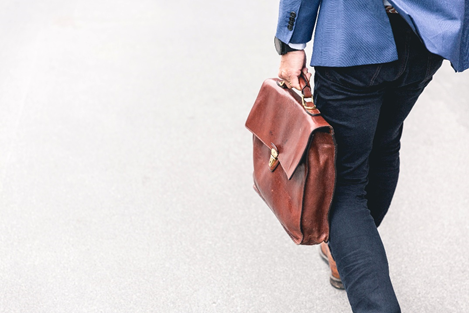 Man carrying a brown satchel