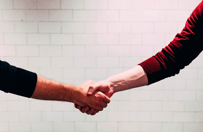 Two hands shaking, closing a deal
