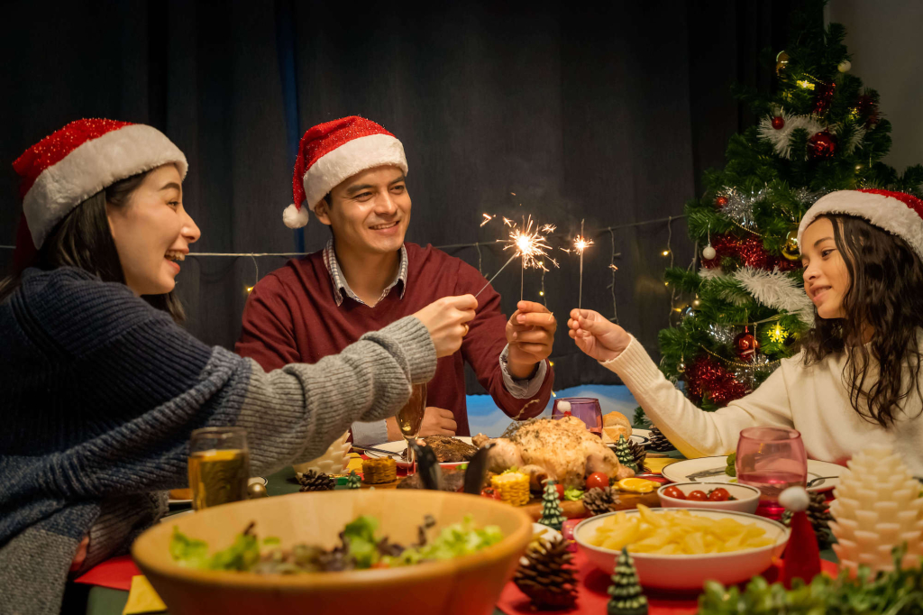 Happy family having dinner together to celebrate christmas
