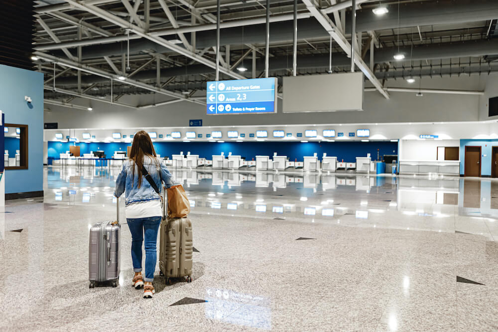 woman-walks-along-airport-with-suitcases(1)