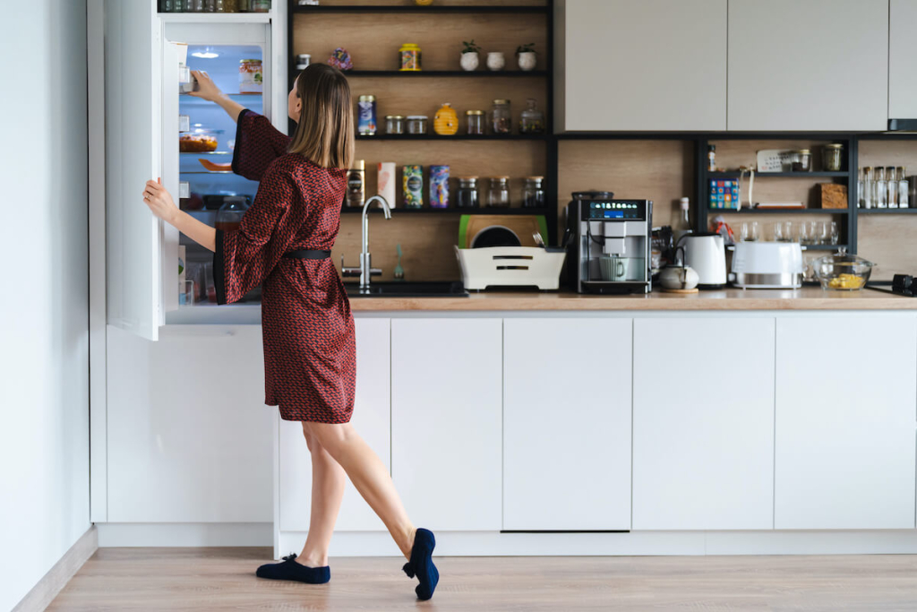 hungry-woman-looking-food-fridge-home-dont-have-much-there-white-kitchen-furniture-home-wear-red-silk-robe