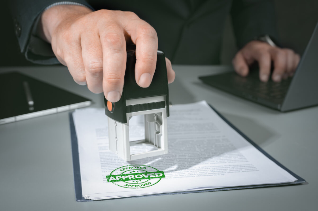 hands-businessman-stamp-paper-document-approve-business-investment-contract-agreement-closeup-person-hand-stamping-with-approved-stamp-document-desk(1)