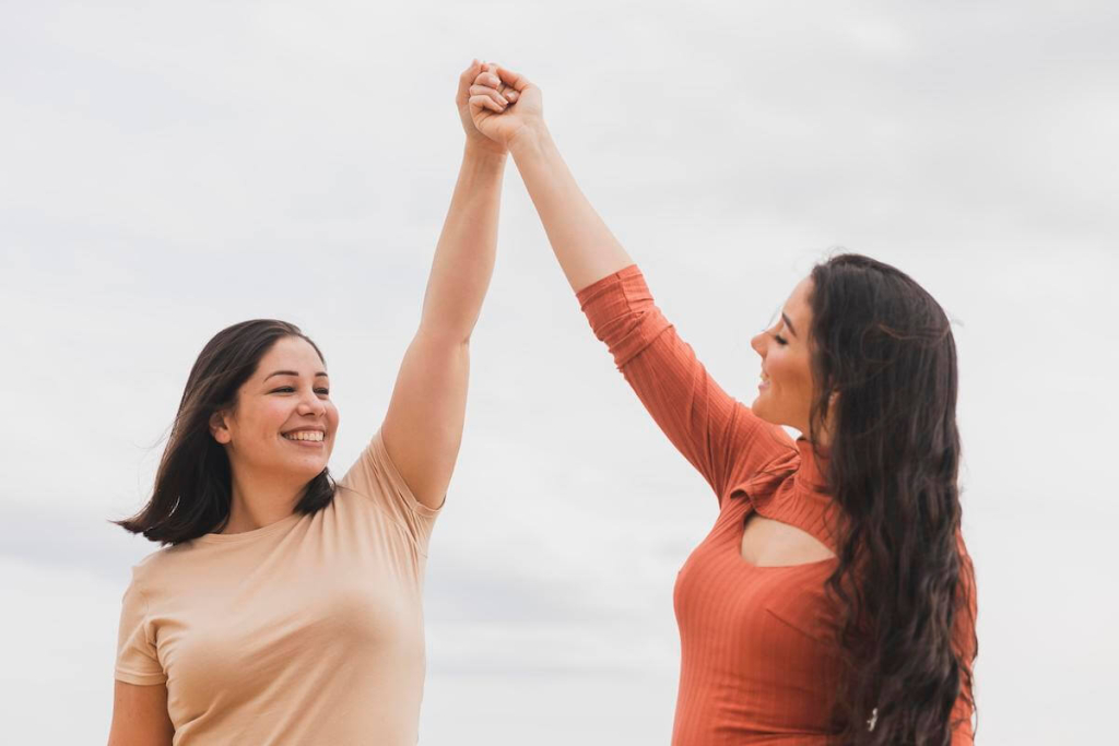 low-angle-women-holding-hands