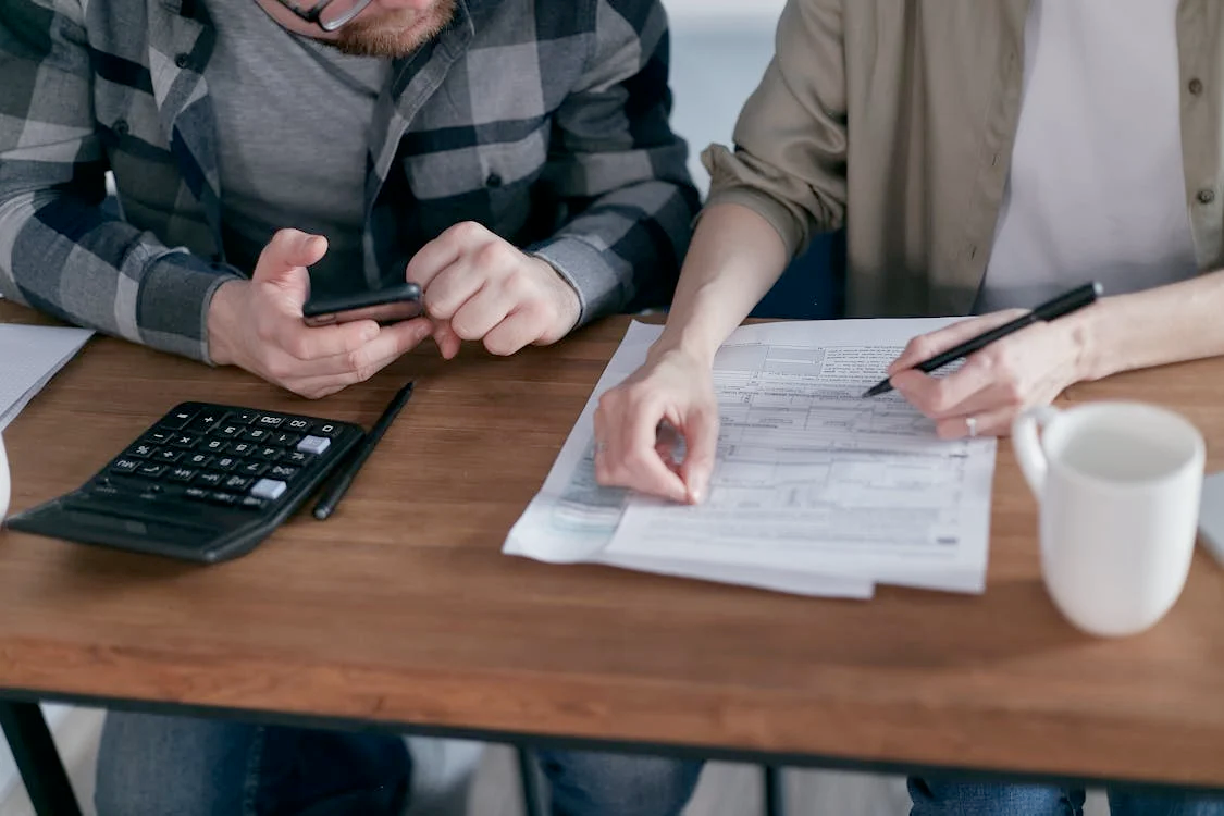 Strengthen your financial future with a solid financial plan l Photo by Mikhail Nilov: https://www.pexels.com/photo/couple-people-smartphone-laptop-6964365/