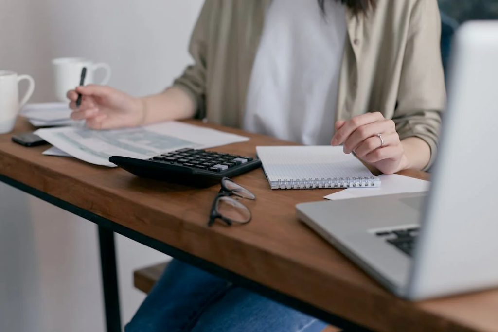 Mid-year financial planning l Photo by Mikhail Nilov: https://www.pexels.com/photo/couple-people-woman-desk-6963857/