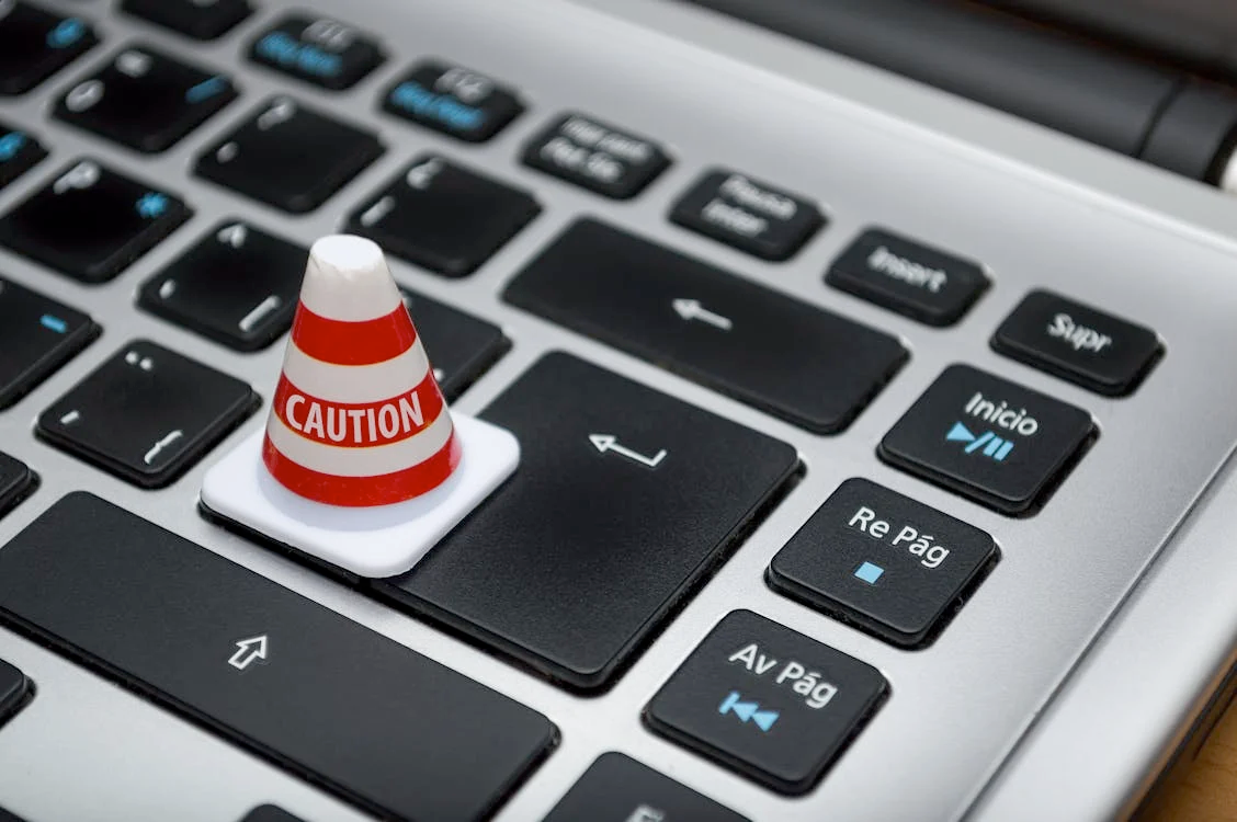 Enhancing parents digital literacy skills l Photo by Fernando Arcos: https://www.pexels.com/photo/white-caution-cone-on-keyboard-211151/