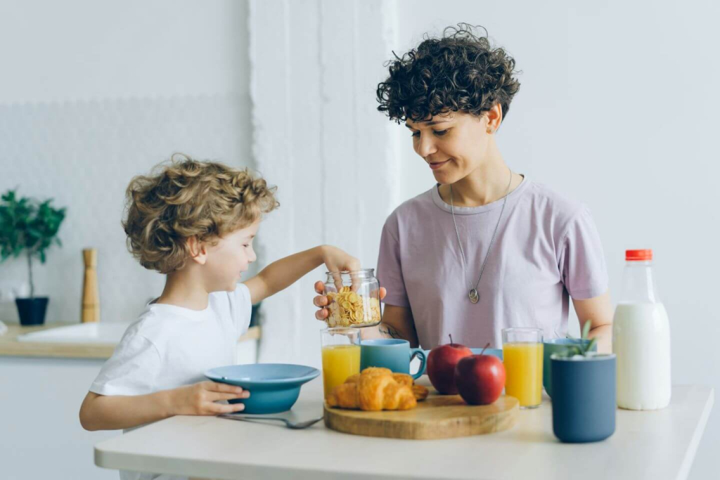 a woman and a child are having breakfast together